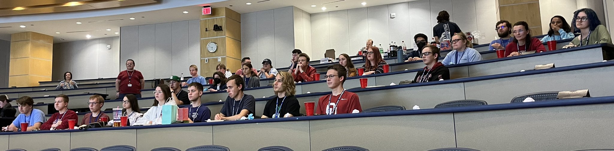Several dozen meteorology students look on in a lecture hall. 
